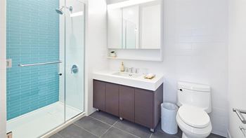 Custom-built, tri-view mirrored medicine cabinet with open shelf and led light diffuser